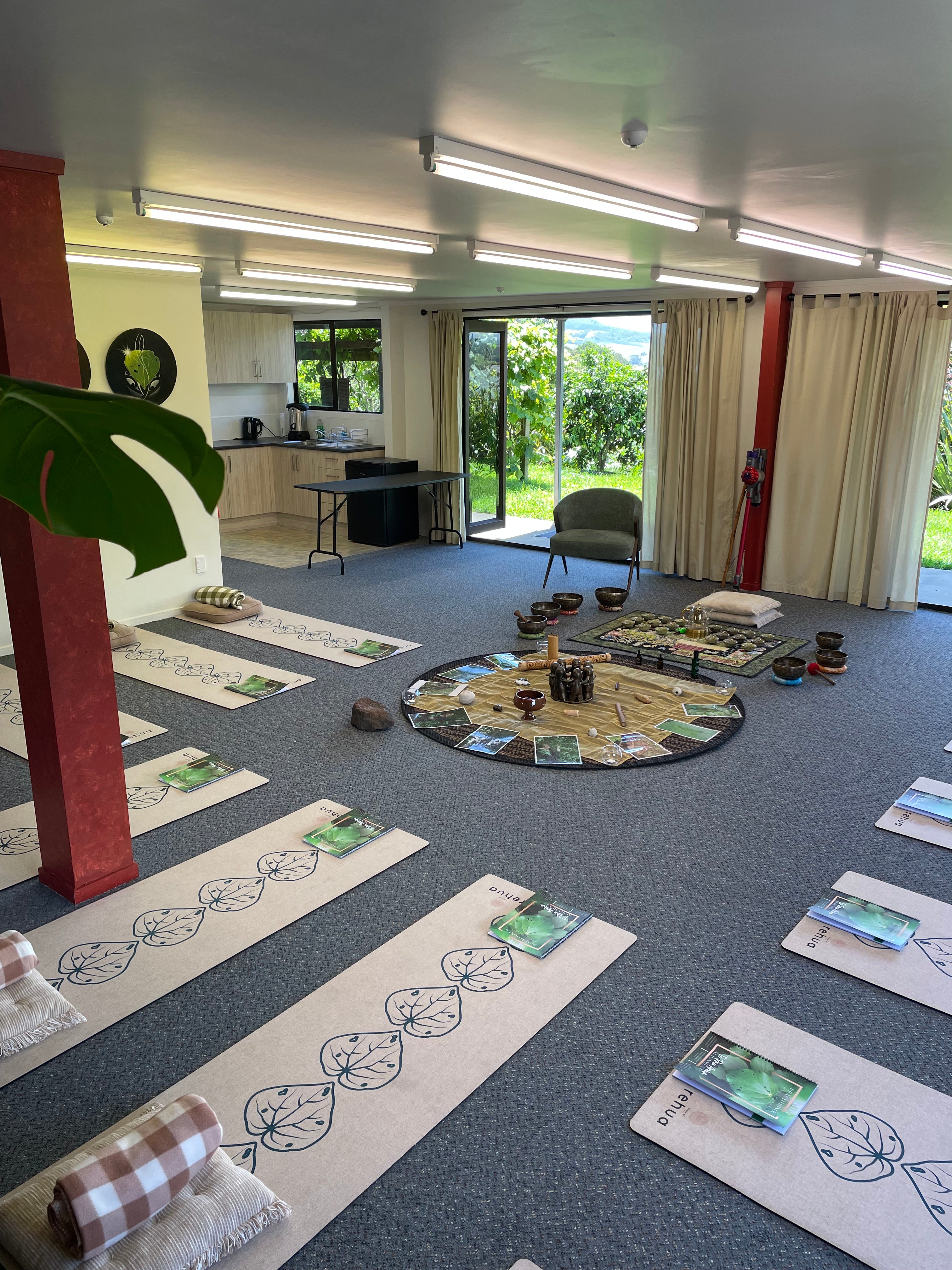 Room with a round mirror on a gray floor, surrounded by patterned tiles.