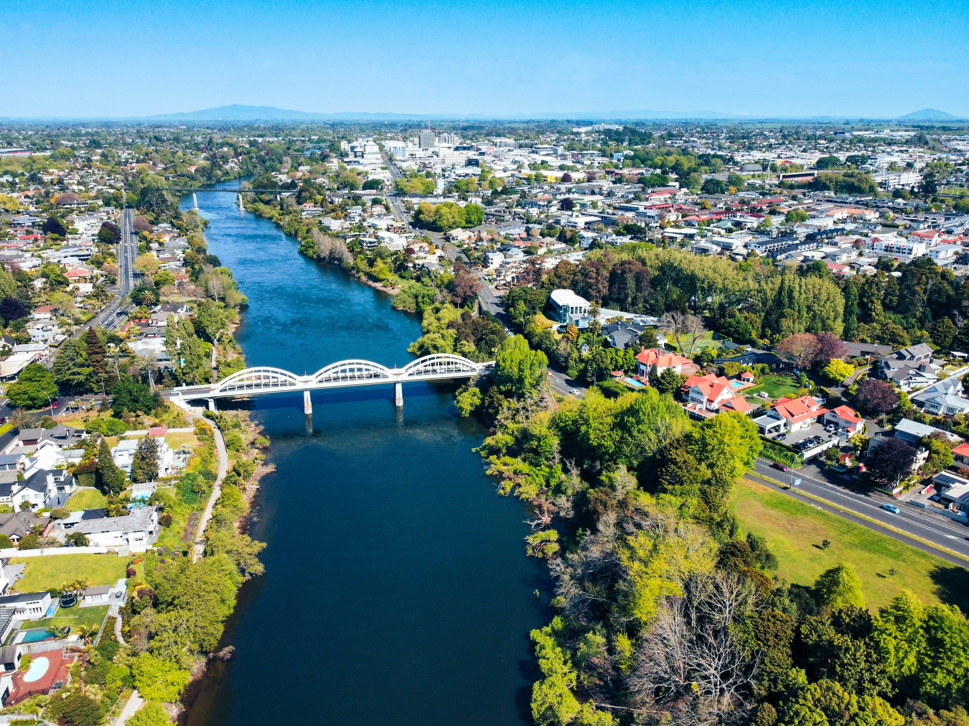 Aerial view of a waikato city with a river and bridge