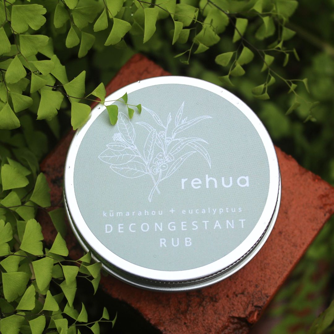 Rehua decongestant rub container on a natural background with green leaves