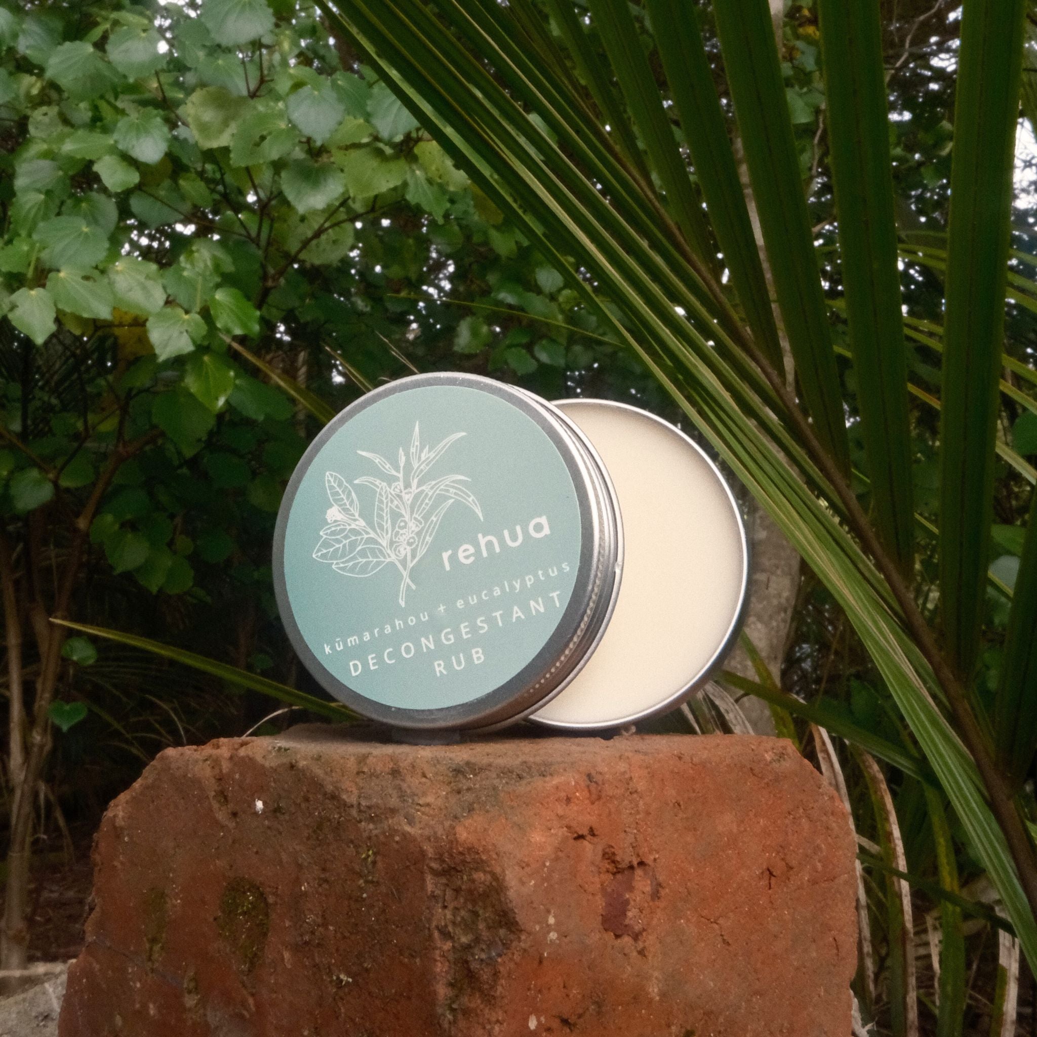decongestant  'rehua' product on a stone surface with green foliage in the background