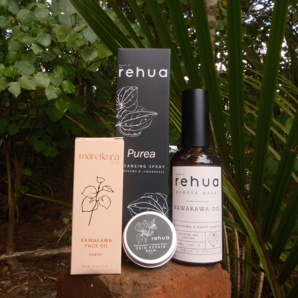 Collection of Rehua skincare products including a bottle, box, and jar against a natural background.