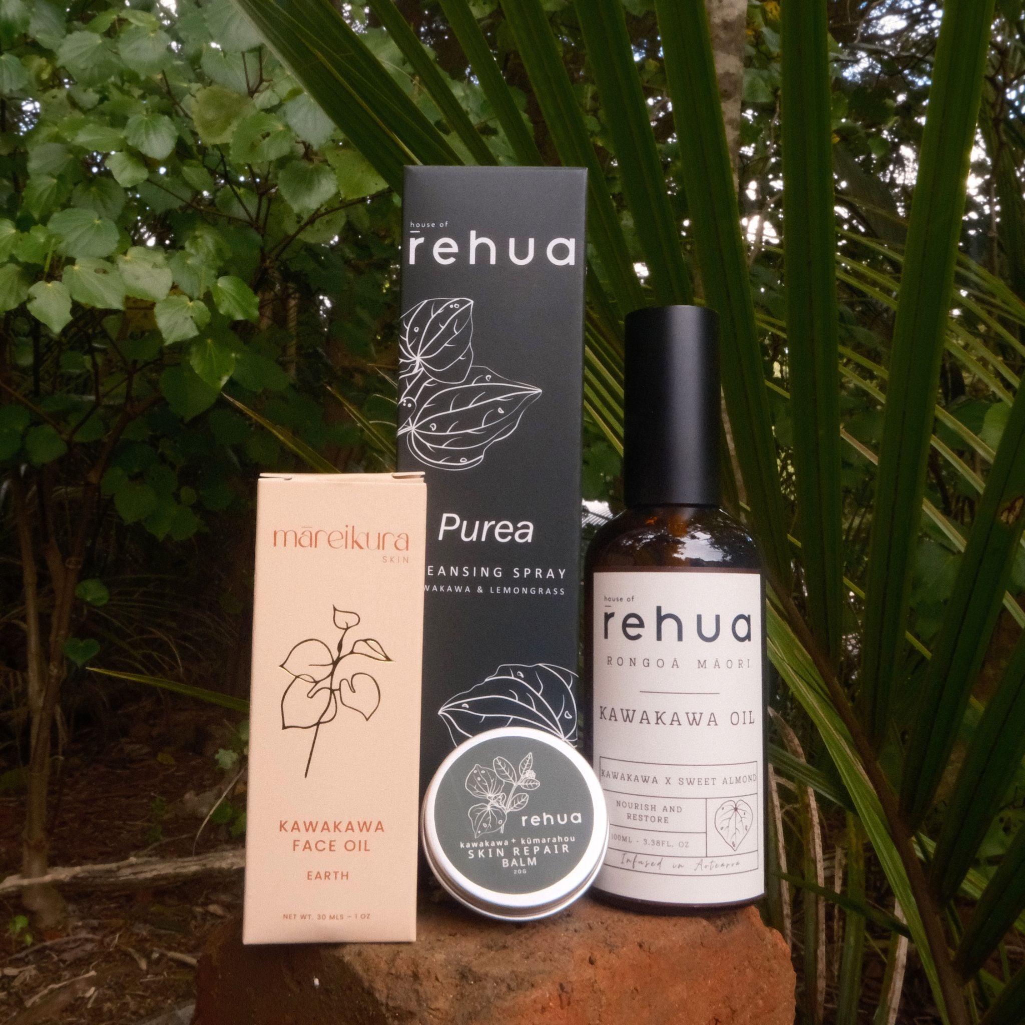 Collection of Rehua skincare products including a bottle, box, and jar against a natural background.