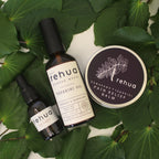 House of Rehua products including oil, balm, and tincture on kawakawa leaves