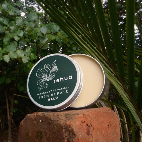 Skin repair balm in a tin with 'rehua' branding against a natural background