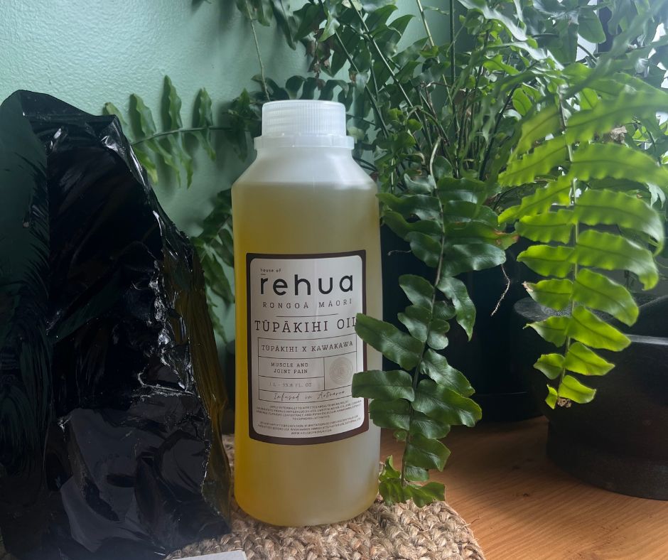 Bottle of Rehua Tupakihi Oil with plants in the background