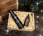 Two skincare products in a box with 'mareikura' branding, surrounded by festive decorations.