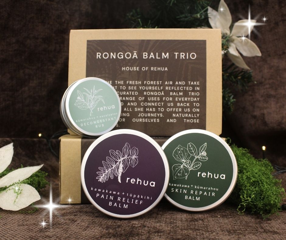 Three balm containers with 'rehua' branding on a wooden surface with packaging in the background.