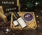 Gift set with rehua products including a bottle, dropper, and balm in a decorative box.