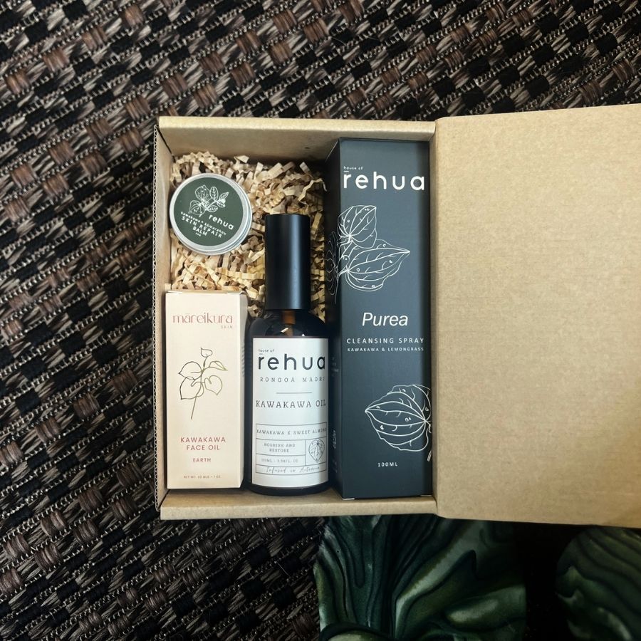 Set of Rehua skincare products in a box against a textured dark background