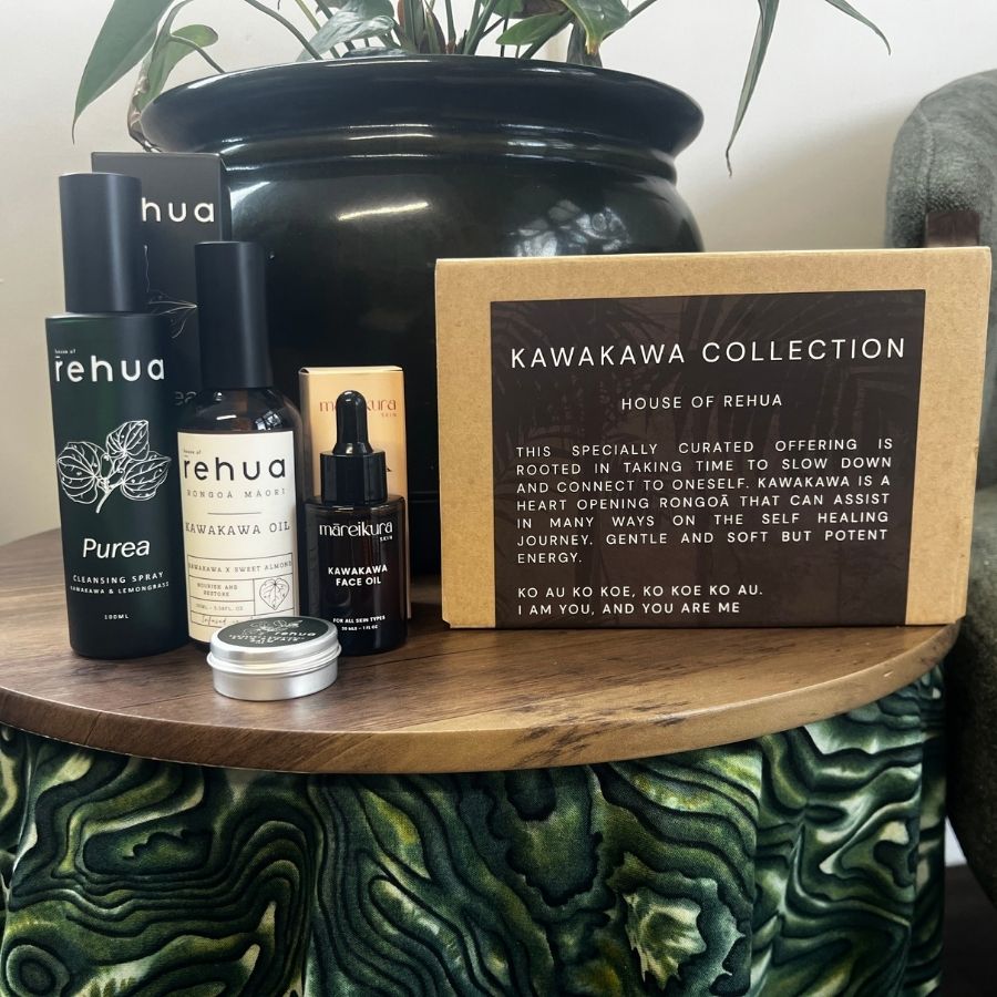 House of Rehua products including bottles and a box on a wooden surface with a plant in the background.