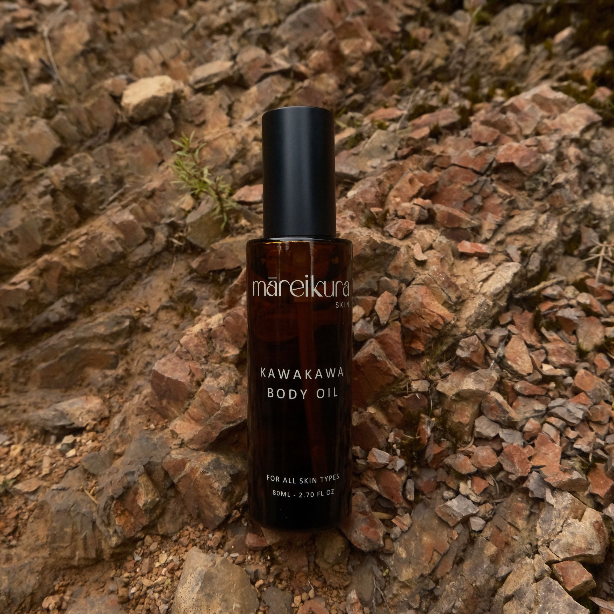 Bottle of Mareikura Skin Kawakawa Body Oil on a stone surface