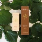 Two skincare product boxes from mareikura on a background of green leaves
