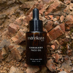 Maneikura Kawakawa Face Oil bottle on a stone background