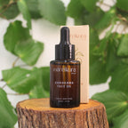Mareikura Skin Kawakawa Face Oil bottle and box on a wooden stump with kawakawa leaves in the background