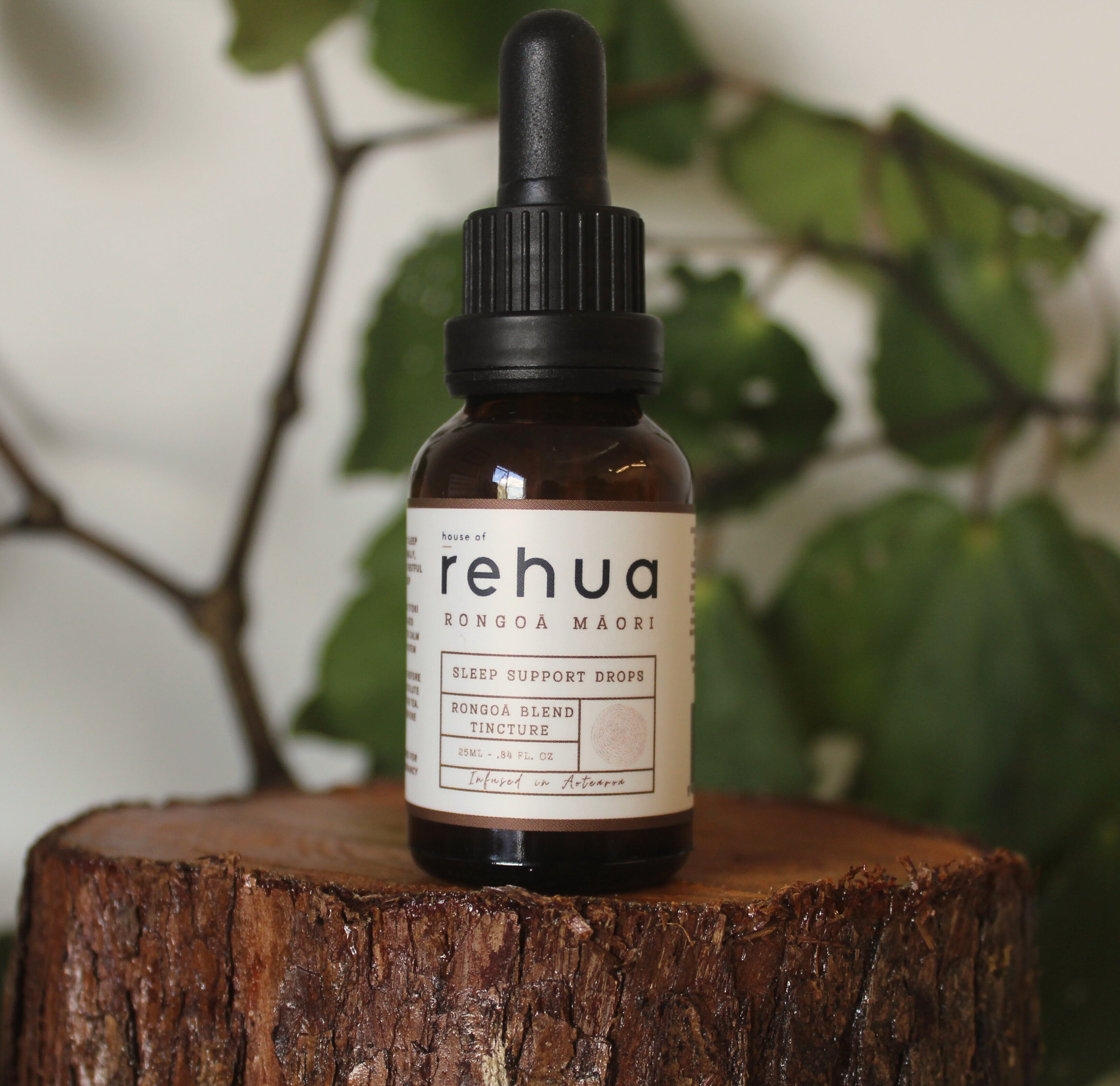 Bottle of rehua sleep support drops on a wooden surface with a natural background