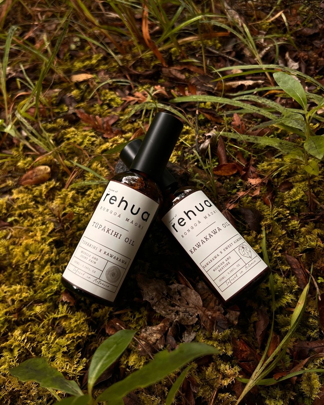 Two bottles of tehua skincare products on a natural background with grass and leaves.