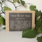 Pain Relief Trio packaging with text on a natural background