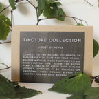 Card with 'Tincture Collection' text on a natural background with leaves