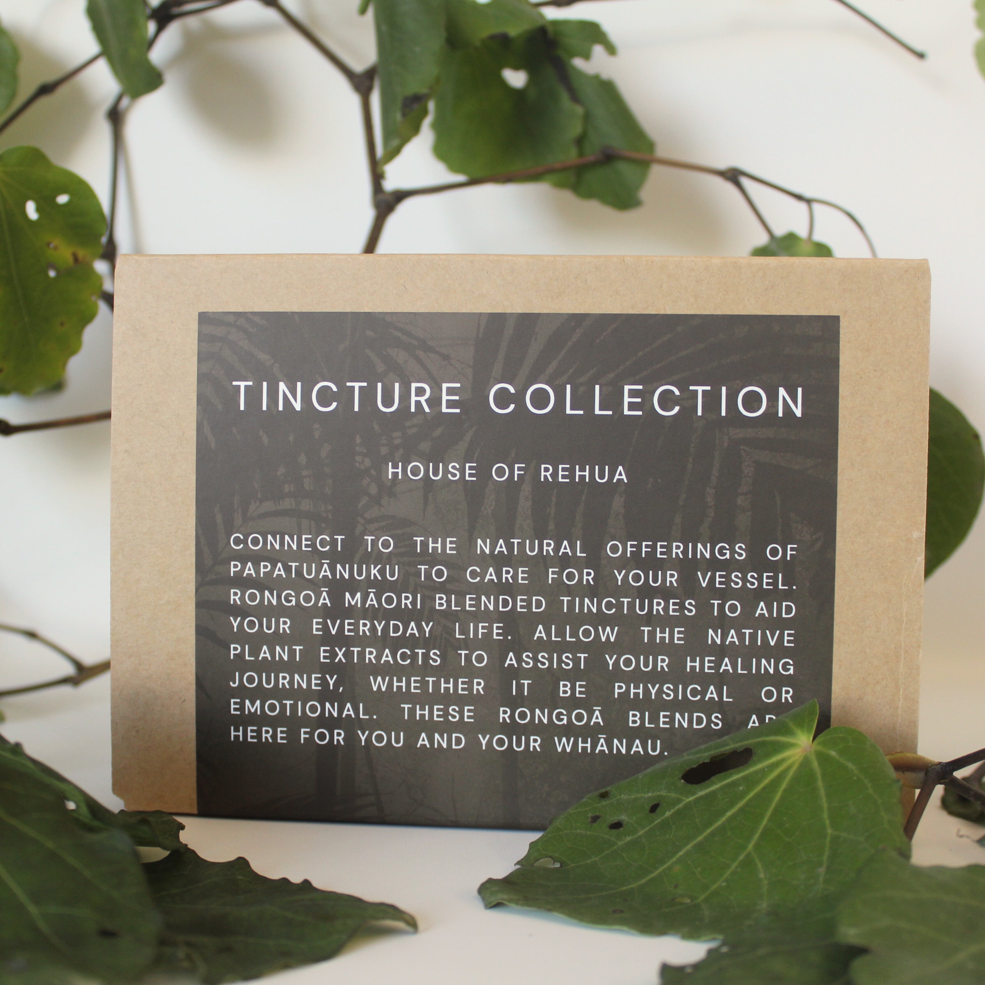Card with 'Tincture Collection' text on a natural background with leaves